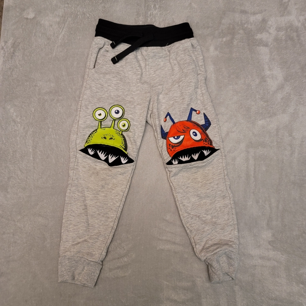 Adorable sweat pants with alien monster knees